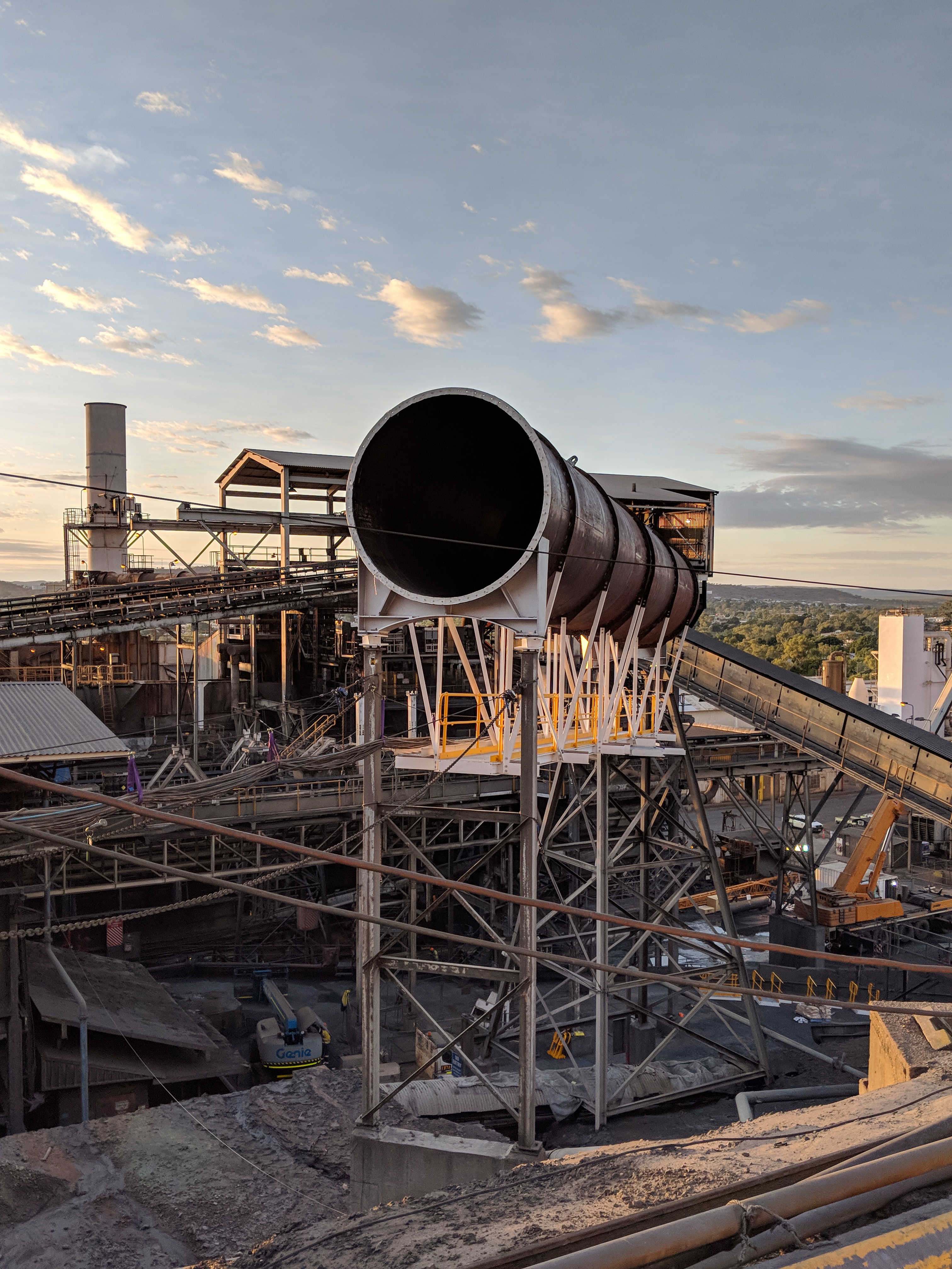 Rotary kiln ducting structure at sunset, lead smelter
